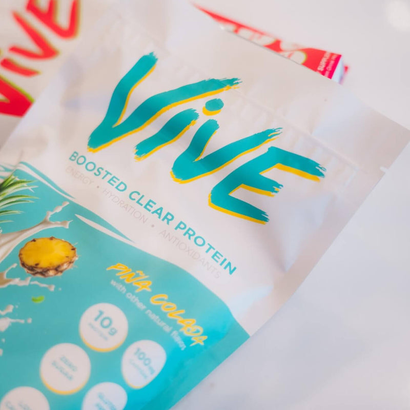 Close up of Vive protein package with pineapple illustration on a white background