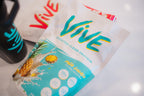 Protein powder package with pineapple illustration and 'Vive' branding on a white surface. Best protein powder