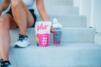 Person sitting on steps with 'Vive' protein powder and shaker bottle