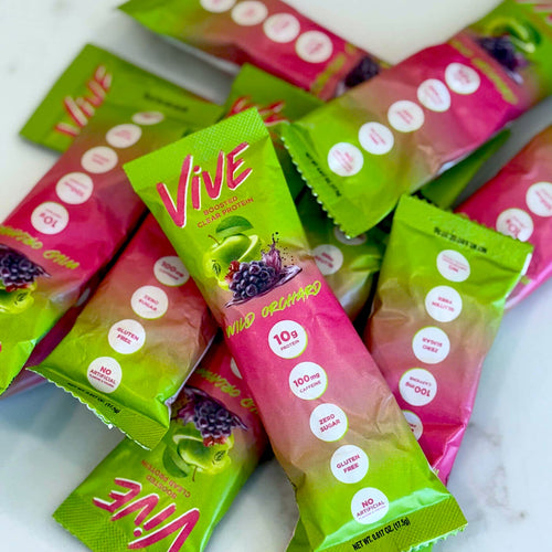 Vive Wild Orchard flavor clear protein powder stick packs with pineapple flavor on a white countertop. Protein Shakes